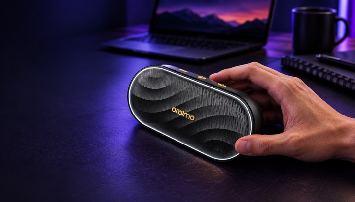 Illustrative lifestyle scene of Oraimo SpaceBox speaker on a purple-lit desk